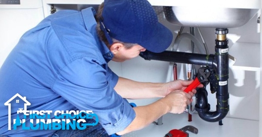 Plumber fixing sink drain